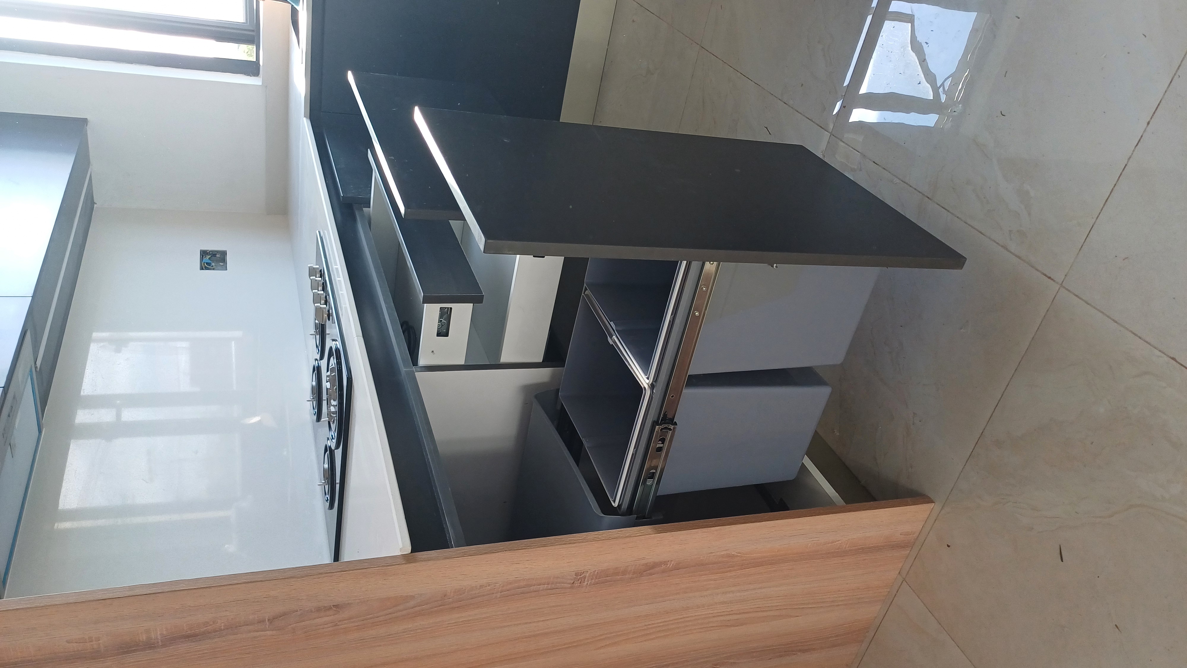 A kitchen furniture highlighting the drawers and bin pull-out accessory