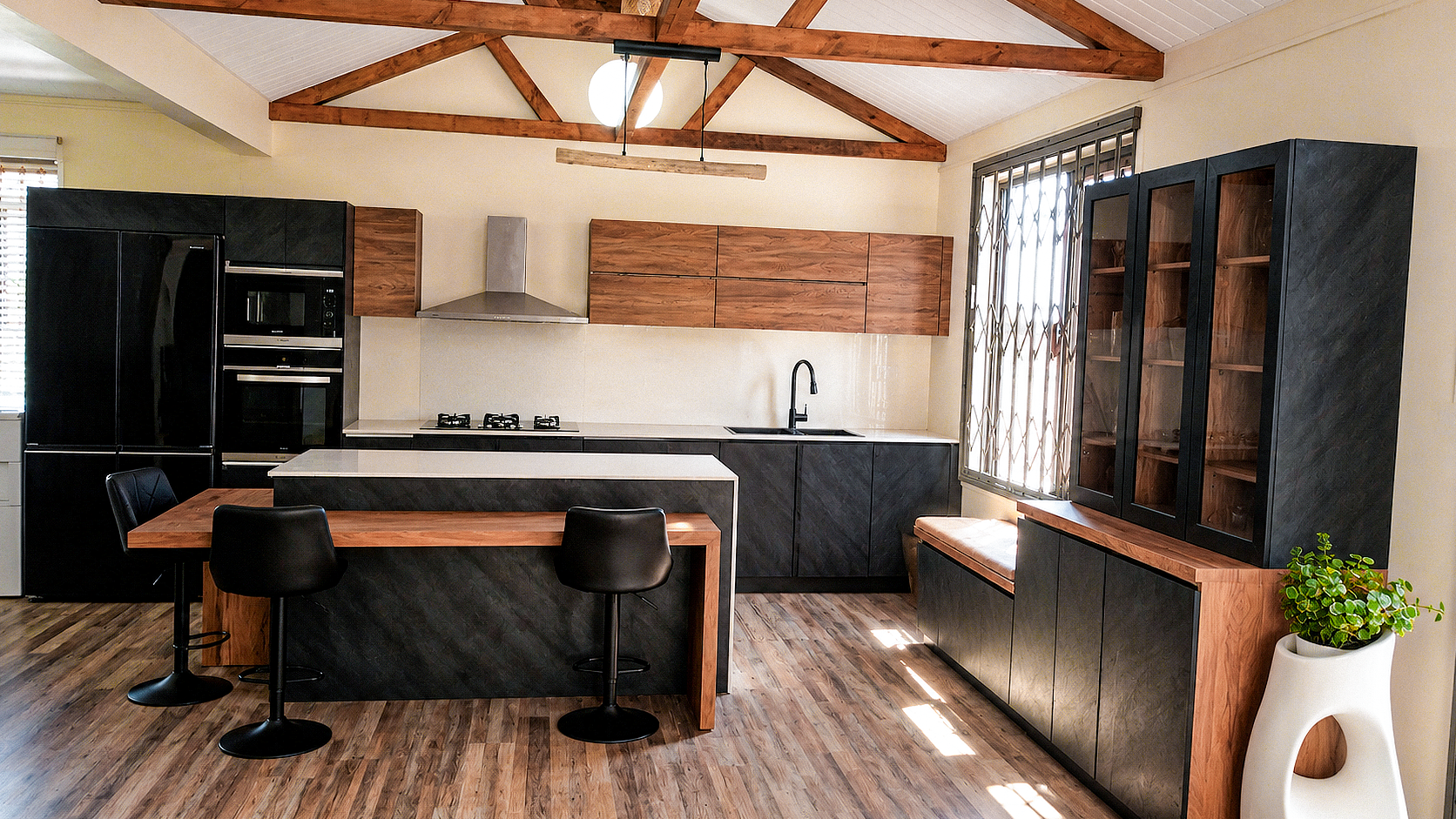 Custom fitted cabinetry with clean melamine surfaces in a lived-in kitchen.